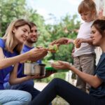 Poor people receiving food from volunteers outdoors