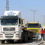 Palestinian trucks passing through the Kerem Shalom crossing, the main passage point for goods entering Gaza from Israel, in the southern Gaza Strip, on May 12, 2019. Photo by Abed Rahim Khatib