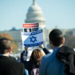 WASHINGTON DC, USA NOVEMBER 14 – A rally participant holds a sign at the March for Israel in Washington DC on November 14, 2023 to show support for Israel