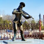 BIROBIDZHAN, RUSSIA – MARCH 9, 2008: Fiddler on the Roof statue at the Theater Square. The statue of Tevye the Dairyman, the character of tales by Sholem Aleichem, was erected in 2004.