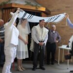 Jewish bride and Jewish bridegroom married in a modern Orthodox Jewish wedding ceremony in a synagogue.Real people. Copy space
