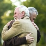 Mature men hugging, happy to see each other, old friends meeting, greeting