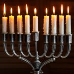 Jewish holiday Hanukkah with menorah (traditional Candelabra), donuts and wooden dreidels (spinning top), chocolate coins.  Inscription on the menorah "Olive oil"