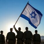 Silhouettes of religious Israeli soldiers standing and holding the Israeli flag